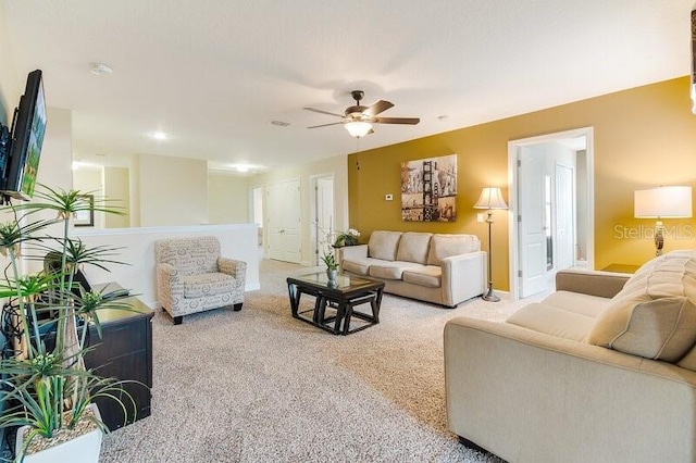 carpeted living room featuring ceiling fan