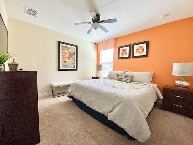 bedroom with ceiling fan and light colored carpet