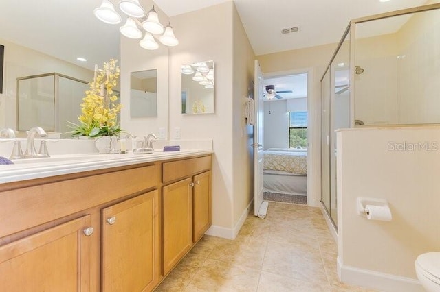 bathroom with ceiling fan, vanity, an enclosed shower, tile patterned floors, and toilet