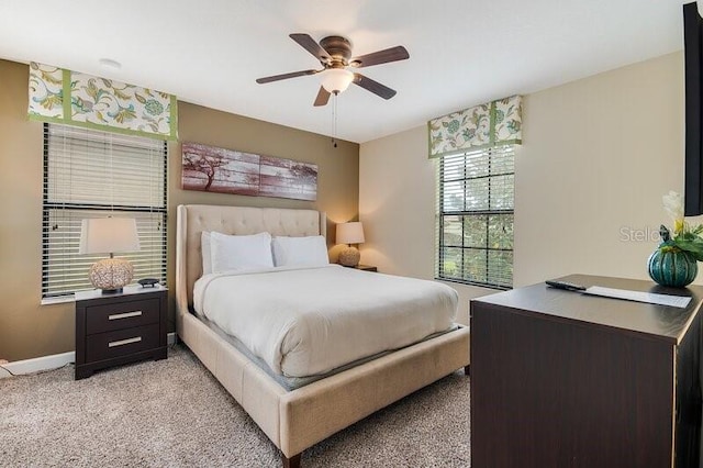 bedroom featuring ceiling fan and light carpet