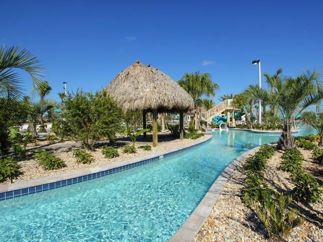 view of pool with a gazebo and a water slide