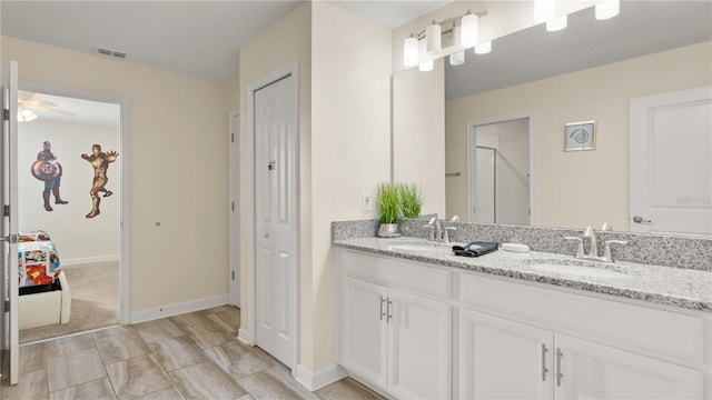 bathroom with ceiling fan and double sink vanity