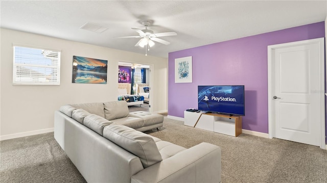 carpeted living room featuring ceiling fan