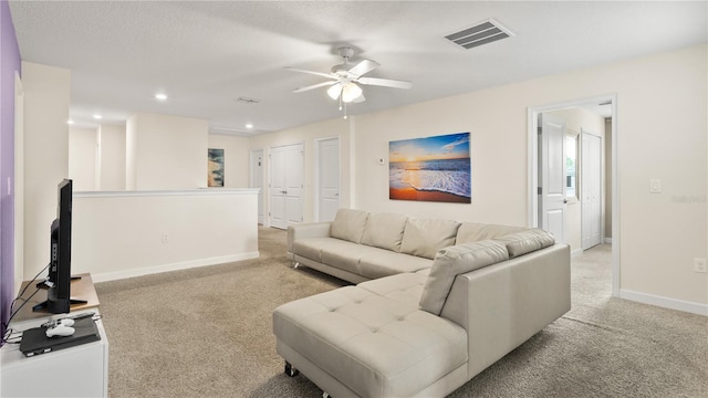 living room featuring ceiling fan and light colored carpet