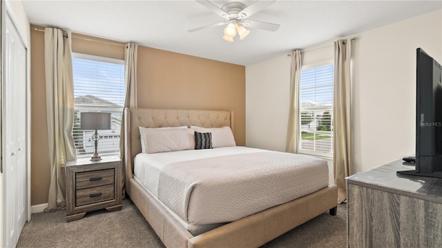 carpeted bedroom with ceiling fan and a closet