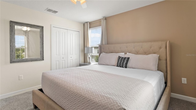 carpeted bedroom featuring ceiling fan and a closet