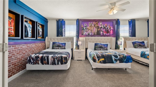 bedroom featuring multiple windows, a textured ceiling, carpet floors, and ceiling fan