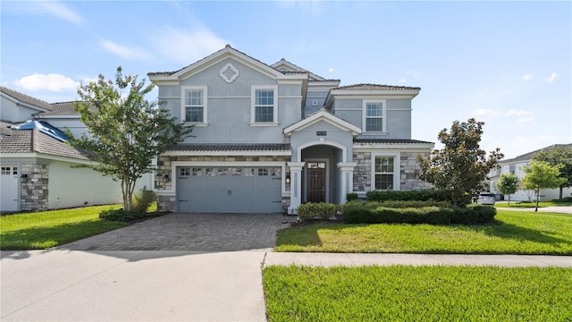 view of front of home with a garage and a front yard