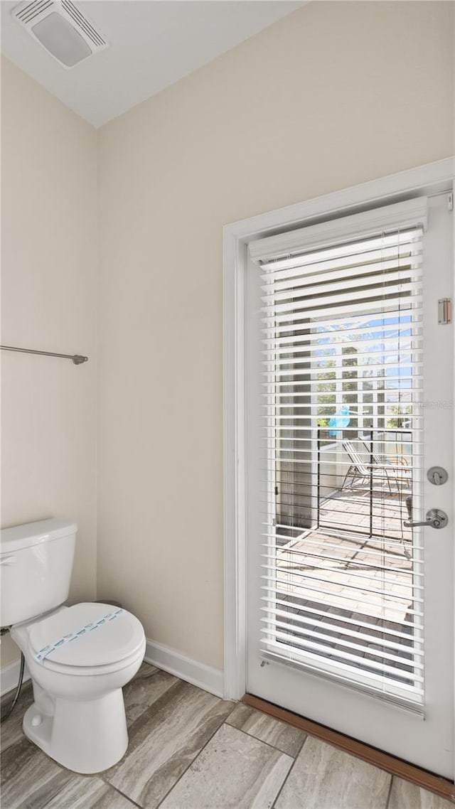 bathroom with hardwood / wood-style floors and toilet