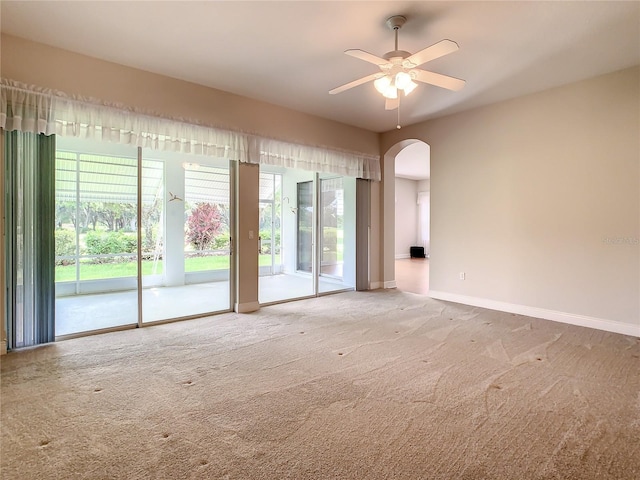 carpeted spare room with ceiling fan