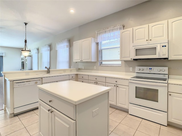 kitchen with pendant lighting, sink, white appliances, a center island, and white cabinets