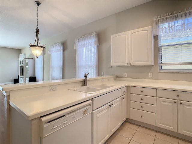 kitchen featuring white cabinetry, white dishwasher, and kitchen peninsula