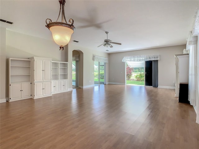 unfurnished living room featuring ceiling fan and light wood-type flooring