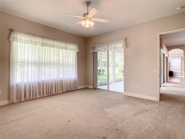 carpeted empty room featuring ceiling fan