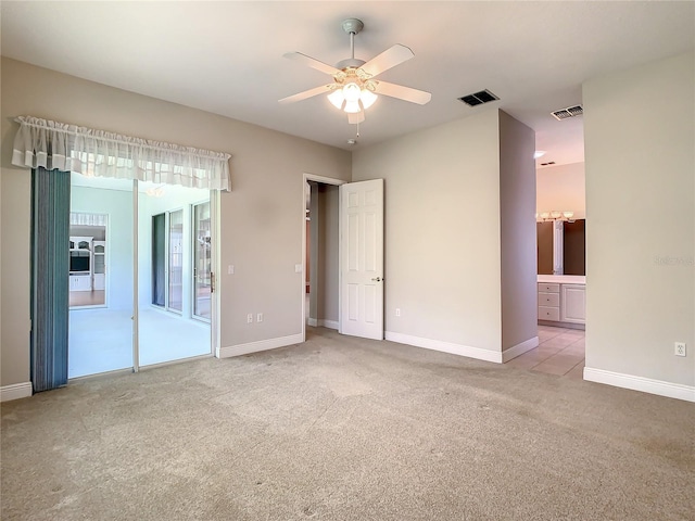 carpeted spare room with ceiling fan