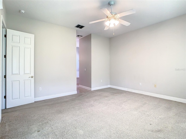 carpeted spare room with ceiling fan