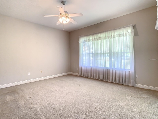 empty room with ceiling fan and carpet floors