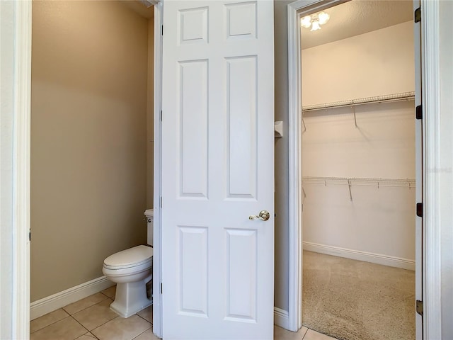 bathroom with tile patterned floors and toilet