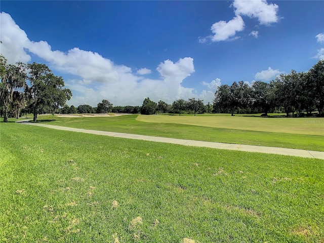 view of property's community with a lawn