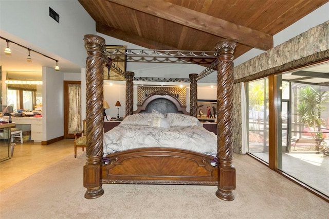 carpeted bedroom featuring access to outside, lofted ceiling with beams, a fireplace, wooden ceiling, and track lighting