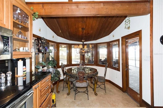 dining area featuring plenty of natural light, vaulted ceiling with beams, and wooden ceiling