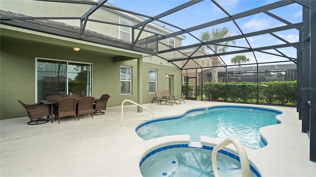 view of swimming pool with a patio area, glass enclosure, and an in ground hot tub