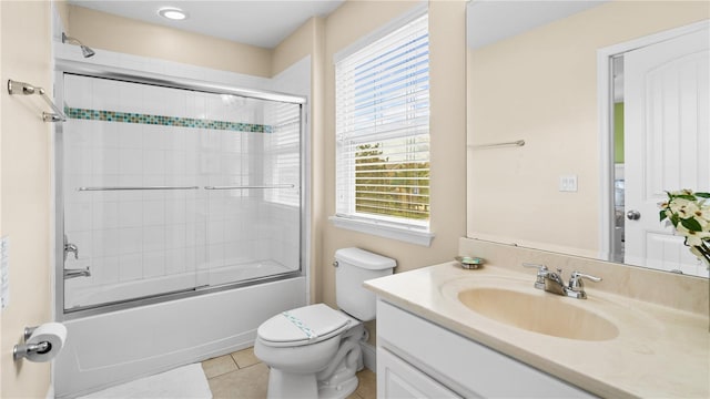 full bathroom featuring vanity, bath / shower combo with glass door, toilet, and plenty of natural light