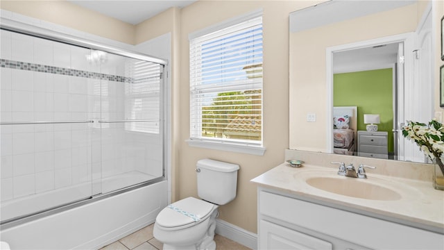 full bathroom with enclosed tub / shower combo, vanity, tile patterned floors, and toilet