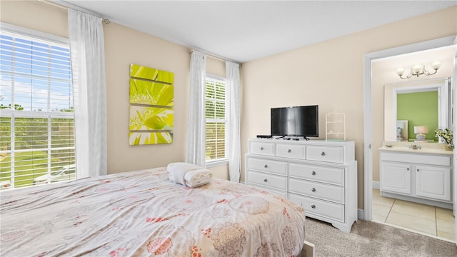 carpeted bedroom featuring connected bathroom and sink