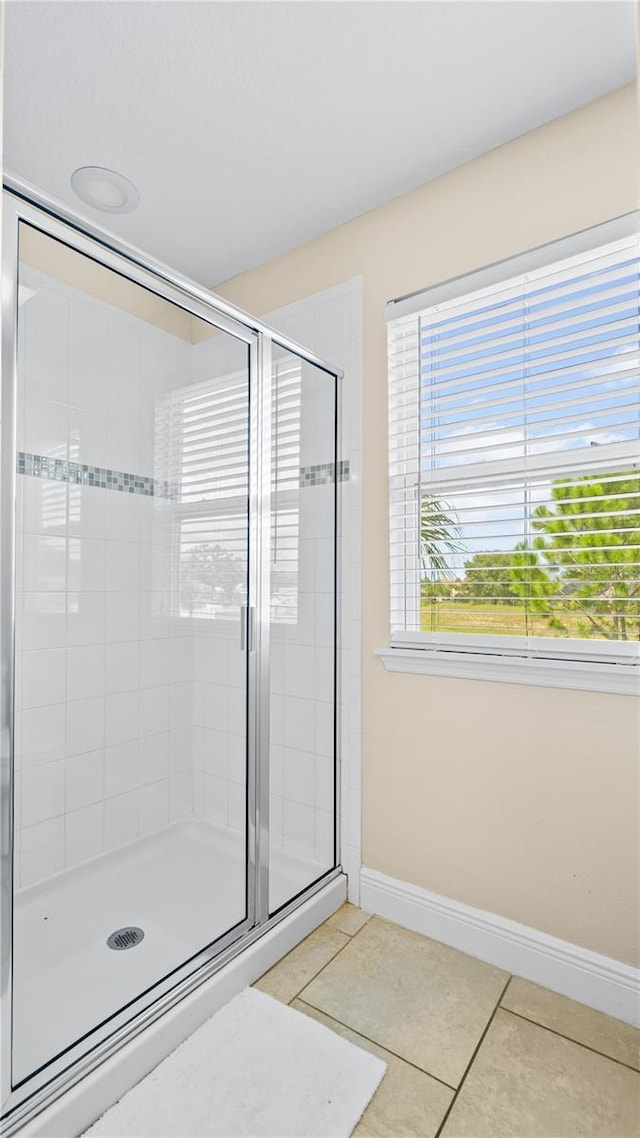 bathroom with tile patterned floors and walk in shower