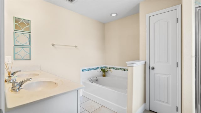 bathroom featuring a washtub, vanity, and tile patterned floors