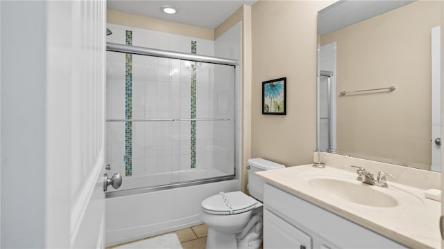 full bathroom with enclosed tub / shower combo, vanity, toilet, and tile patterned floors