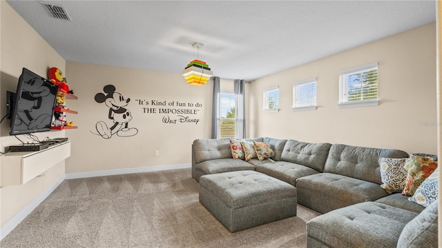 living room featuring a wealth of natural light, light colored carpet, and a textured ceiling