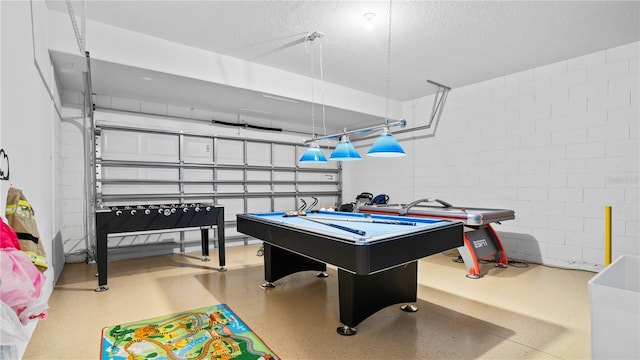 playroom with a textured ceiling