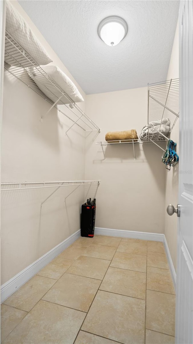 walk in closet featuring tile patterned flooring