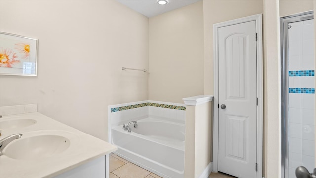 bathroom featuring vanity, a bathtub, and tile patterned floors