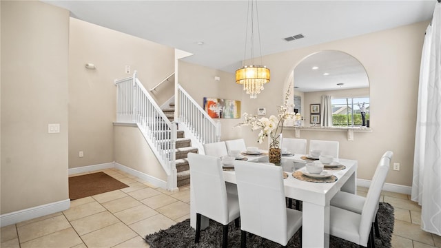 dining area featuring an inviting chandelier and light tile patterned floors