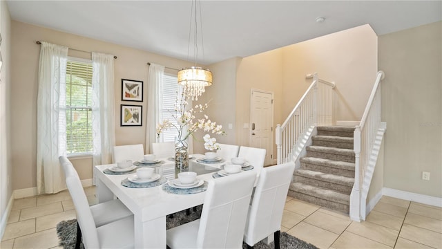 dining area with a chandelier and light tile patterned floors