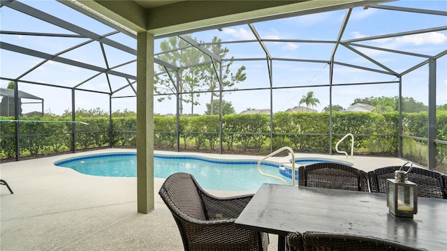 view of pool featuring a patio and glass enclosure