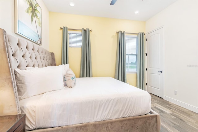 bedroom with light hardwood / wood-style floors, multiple windows, and ceiling fan