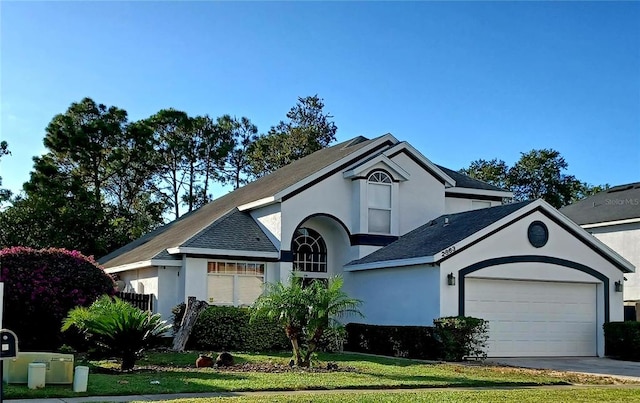 view of front facade featuring a front lawn and a garage