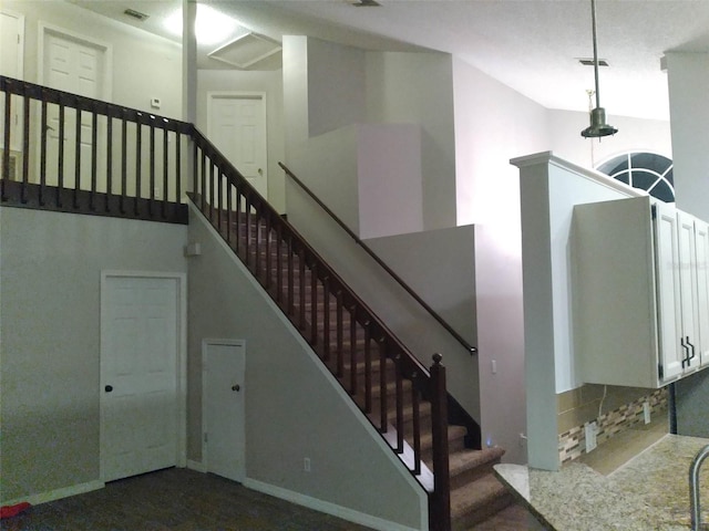 stairway featuring a high ceiling