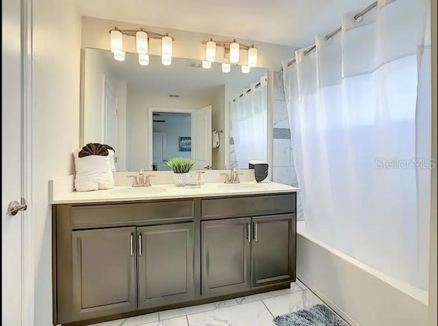 bathroom featuring shower / bath combo and vanity