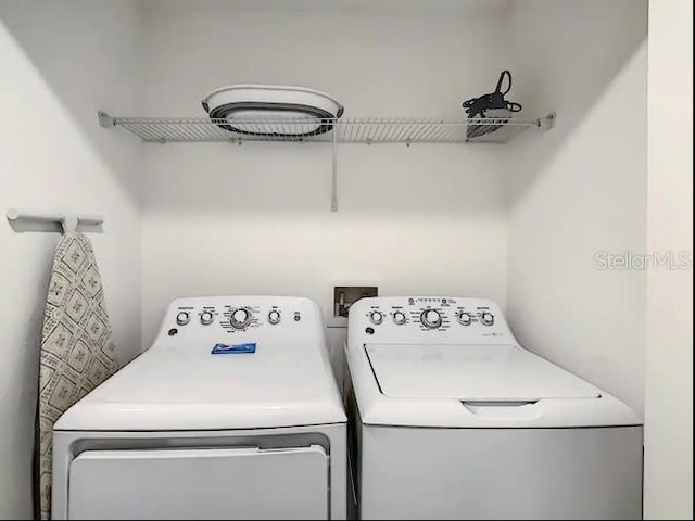 clothes washing area featuring washing machine and dryer