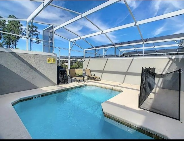 view of pool featuring a patio area and a lanai