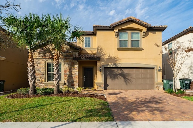 mediterranean / spanish-style house with a front yard and a garage