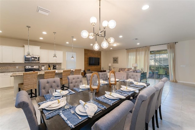 tiled dining room featuring a notable chandelier