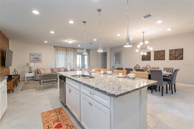 kitchen featuring hanging light fixtures, a kitchen island with sink, white cabinetry, and sink