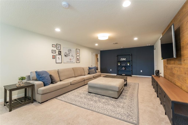 carpeted living room featuring a textured ceiling and wood walls