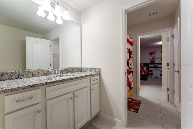 bathroom with tile floors and vanity